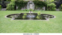 ornamental-pond-set-in-lawn-with-steps-to-grounds-of-formal-garden-g7bmw5.jpg