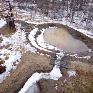 Didn't get all of the digging done before winter, spring thaw reveals need for a much higher back wall.