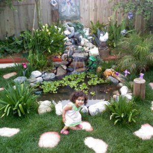 Little niece in front of finished pond