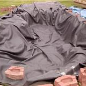 Liner in Sat. May 21 - ok, yeah it's rough, but it's IN and I did it myself, thanks to my IH 574 utility tractor's loader help!