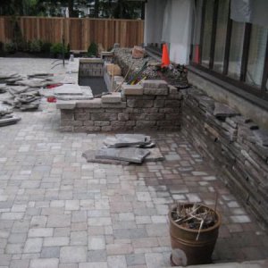 flag stones used to cover foundation wall and cascade waterfalls