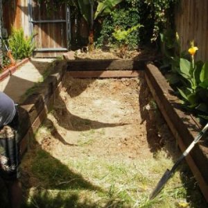 We used railroad ties as the frame.. and we were limited by the space we had on our side yard. I know.. railroad ties are nice looking but highly toxic. I had to carefully overlap the liner once we had it all in.