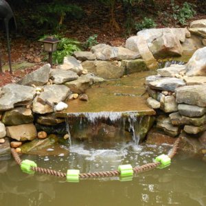 Rope with floaters contains The foam around waterfall