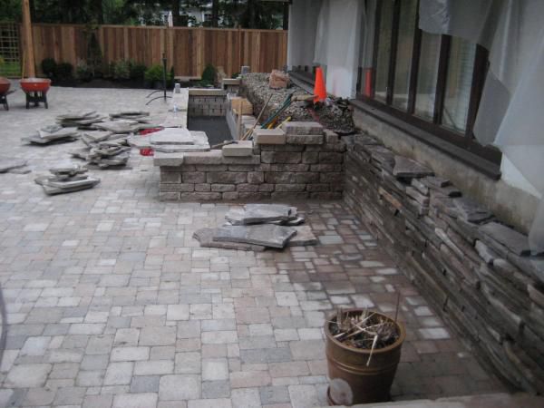 flag stones used to cover foundation wall and cascade waterfalls