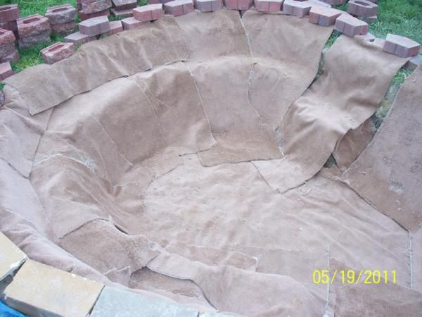 Found 1 year old carpet that was being replaced!  Lining entire pond over block and landscape stones on all edges