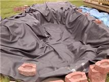 Liner in Sat. May 21 - ok, yeah it's rough, but it's IN and I did it myself, thanks to my IH 574 utility tractor's loader help!